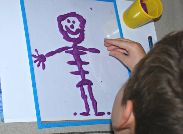 Creating his own skeleton from playdough