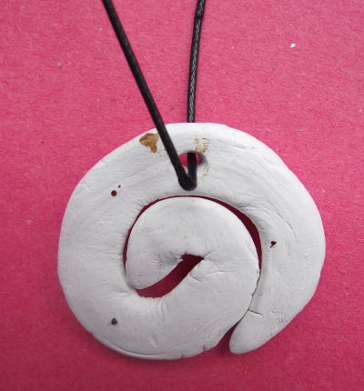 Bone carving necklace in koru shape