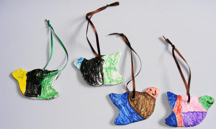 Clay birds decorated with pens