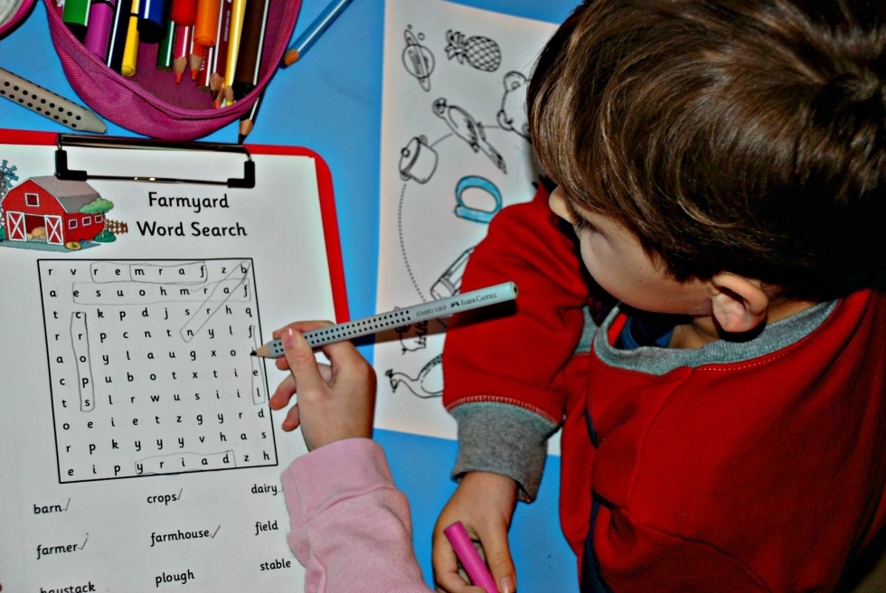 Younger brother fascinated by a word search