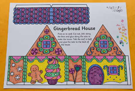 A gingerbread house coloured and ready to cut out