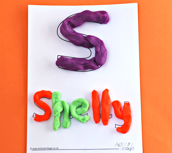Name tracing page completed with playdough
