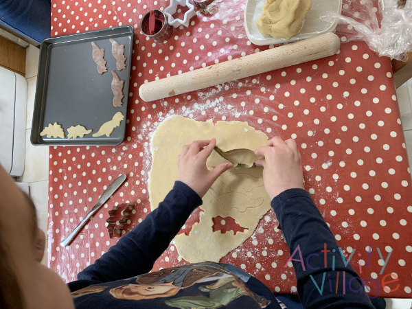 Cutting out dinosaur biscuits