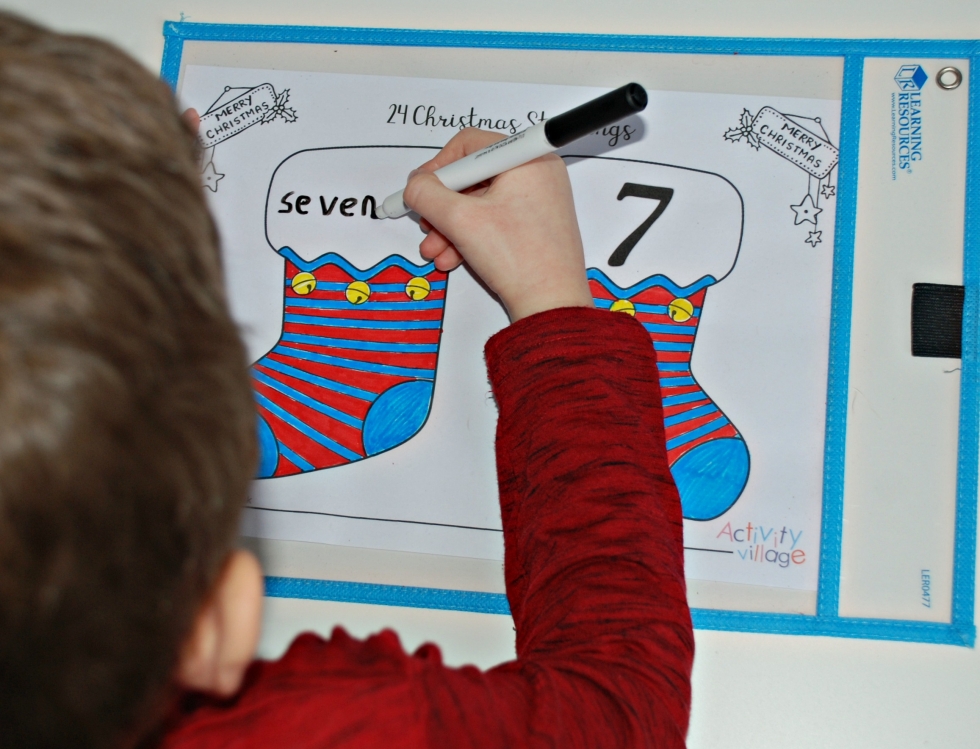 Practising writing number words on the blank Christmas stockings