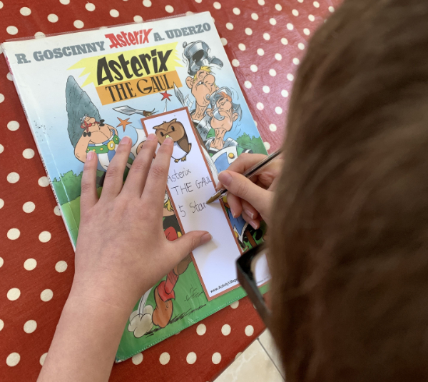 Writing up his latest read on one of the bookmarks