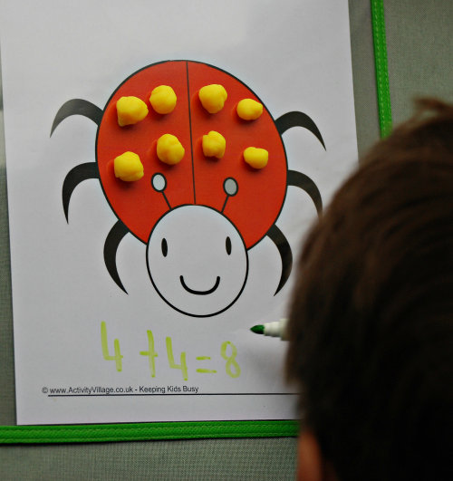 Ladybird playdough mat using playdough spots and with sum written below