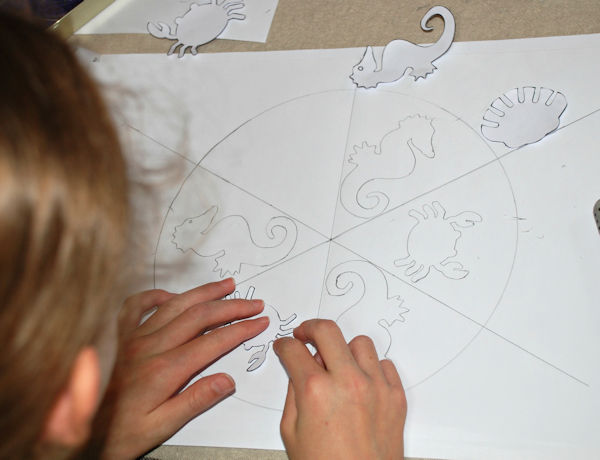 Setting out her sea creature mandala