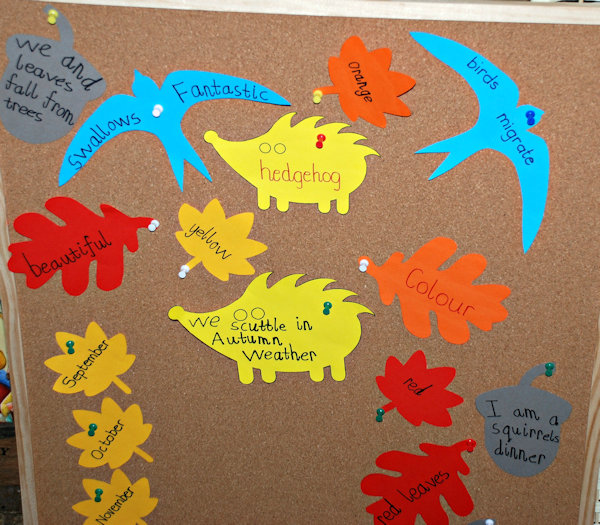 Filling the cork board with his autumn inspired words and phrases