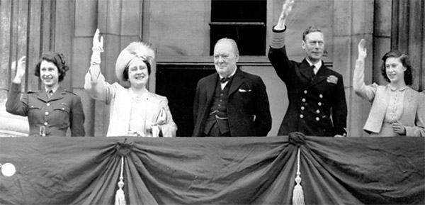 The Royal Family and Winston Churchill wave to the crowds from the balcony at Buckingham Palace