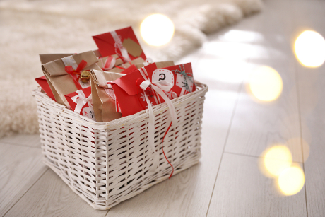 A basket of wrapped gifts for a DIY Advent Calendar