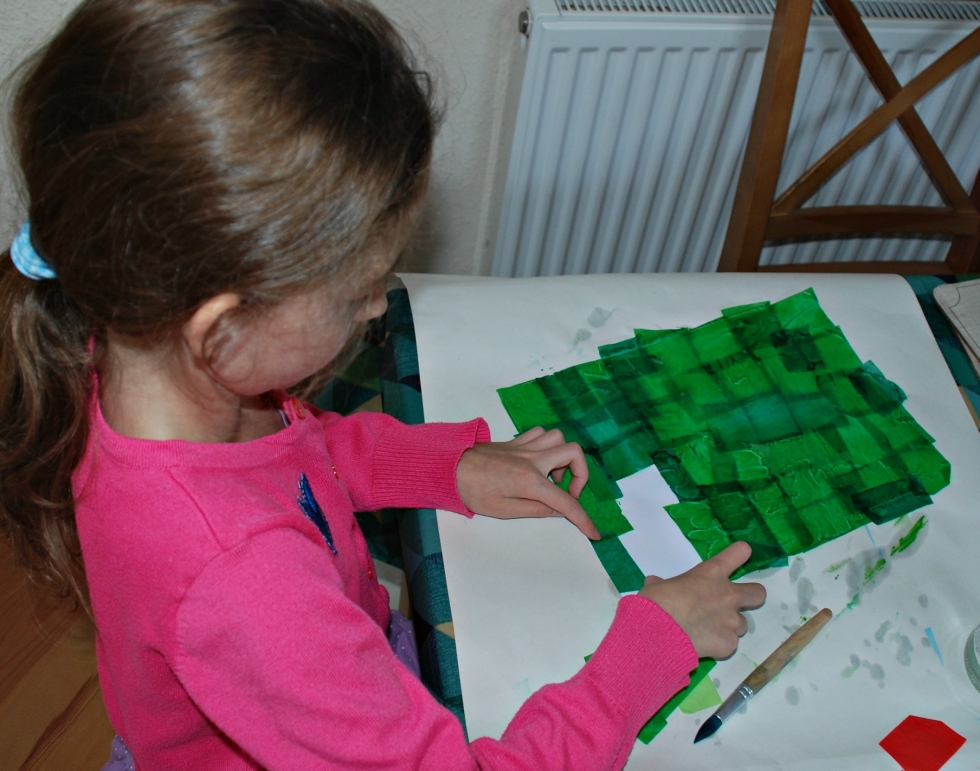 Busy applying tissue paper squares to wet card