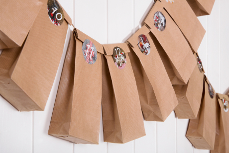 Brown paper packages hanging from string