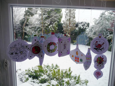 Finished colourings strung in a snowy window!
