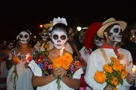 People carrying candles as part of the Day of the Dead festivities