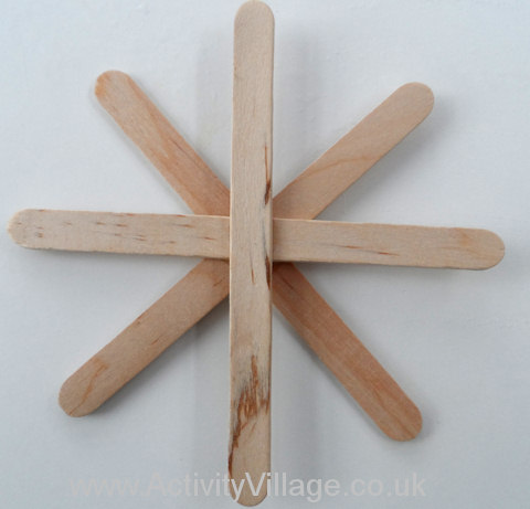 Lolly sticks glued together to form the spider web base