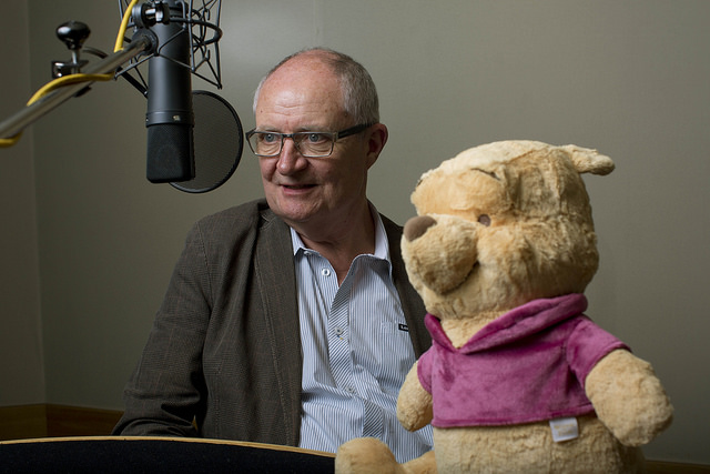 Jim Broadbent with Pooh, reading the story
