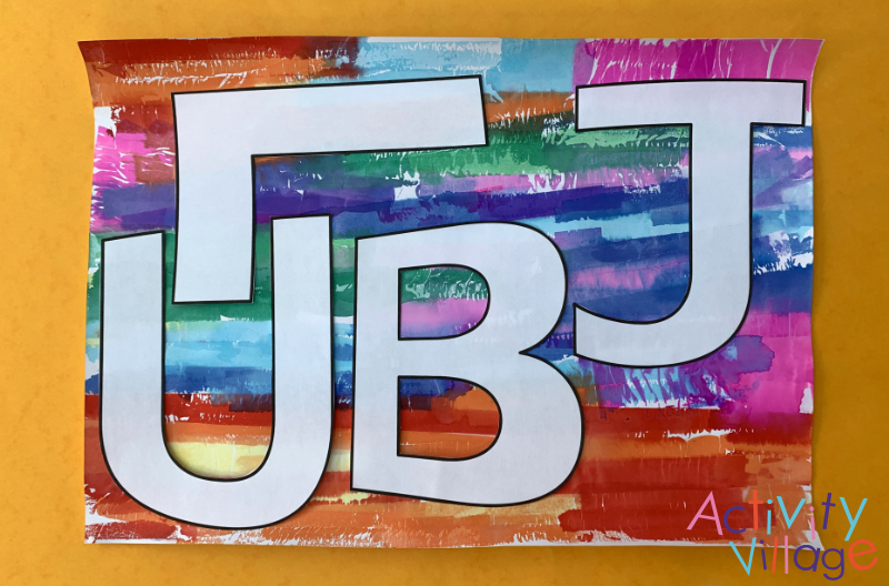 Tracing the letters of "Jubilee" onto tissue-bled card