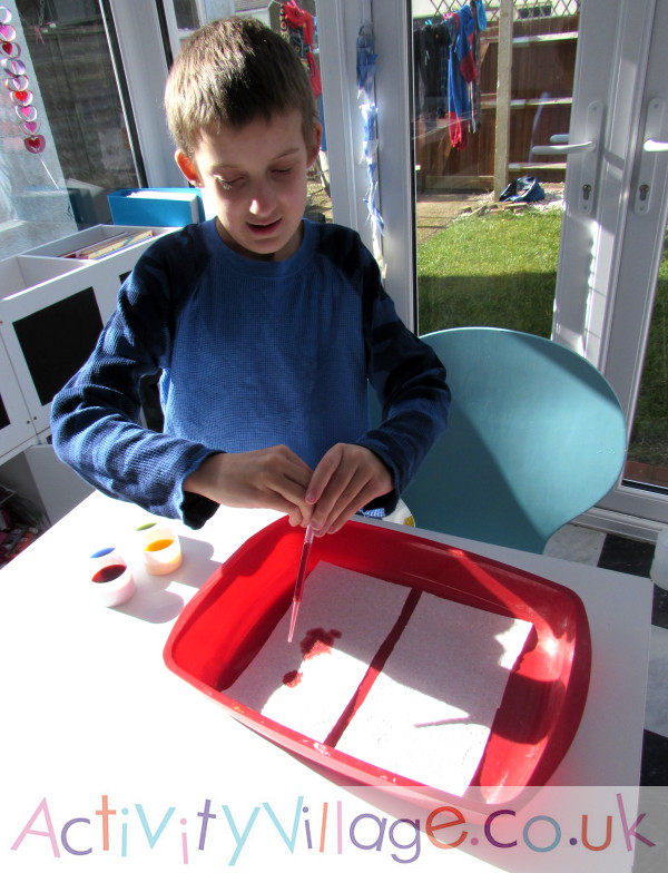 Marbeld clouds craft - Sam dropping food colouring onto kitchen towel