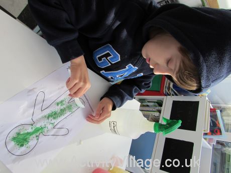 Sam sprinkling his first colour of powder paint onto the template