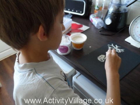 Sam drawing snowflakes with PVA glue