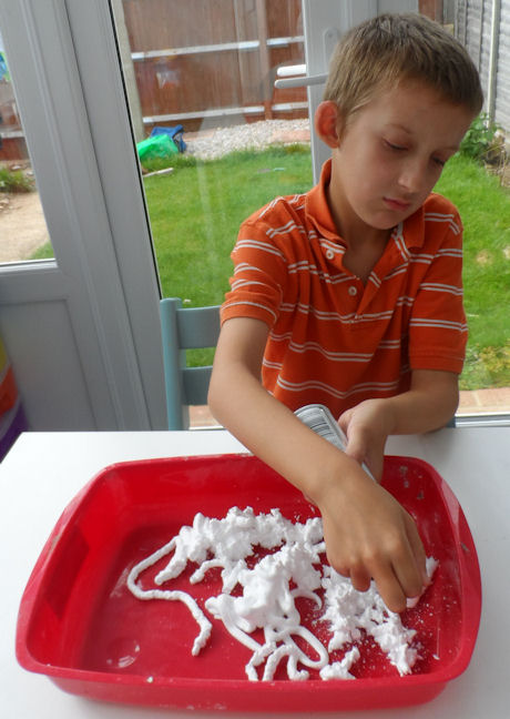 Shaving foam painting - Sam fills the tray