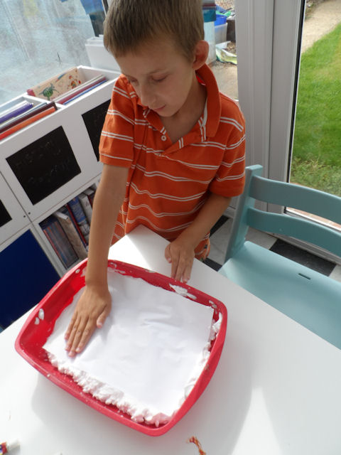 Shaving foam painting - lay a piece of paper on top