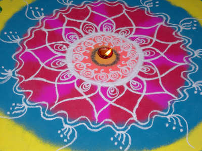 Rangoli design with diya in centre